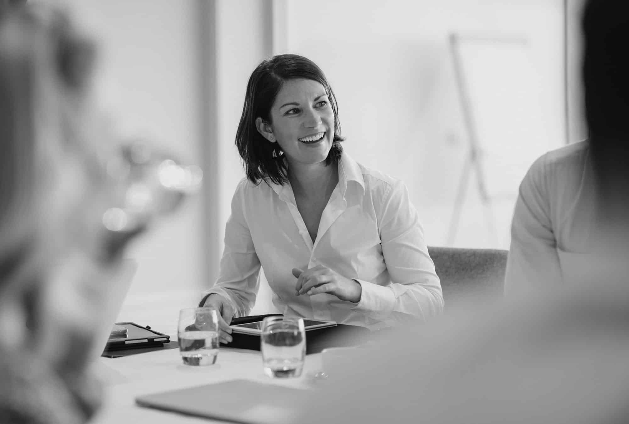 Woman Smiling While Discussing Business